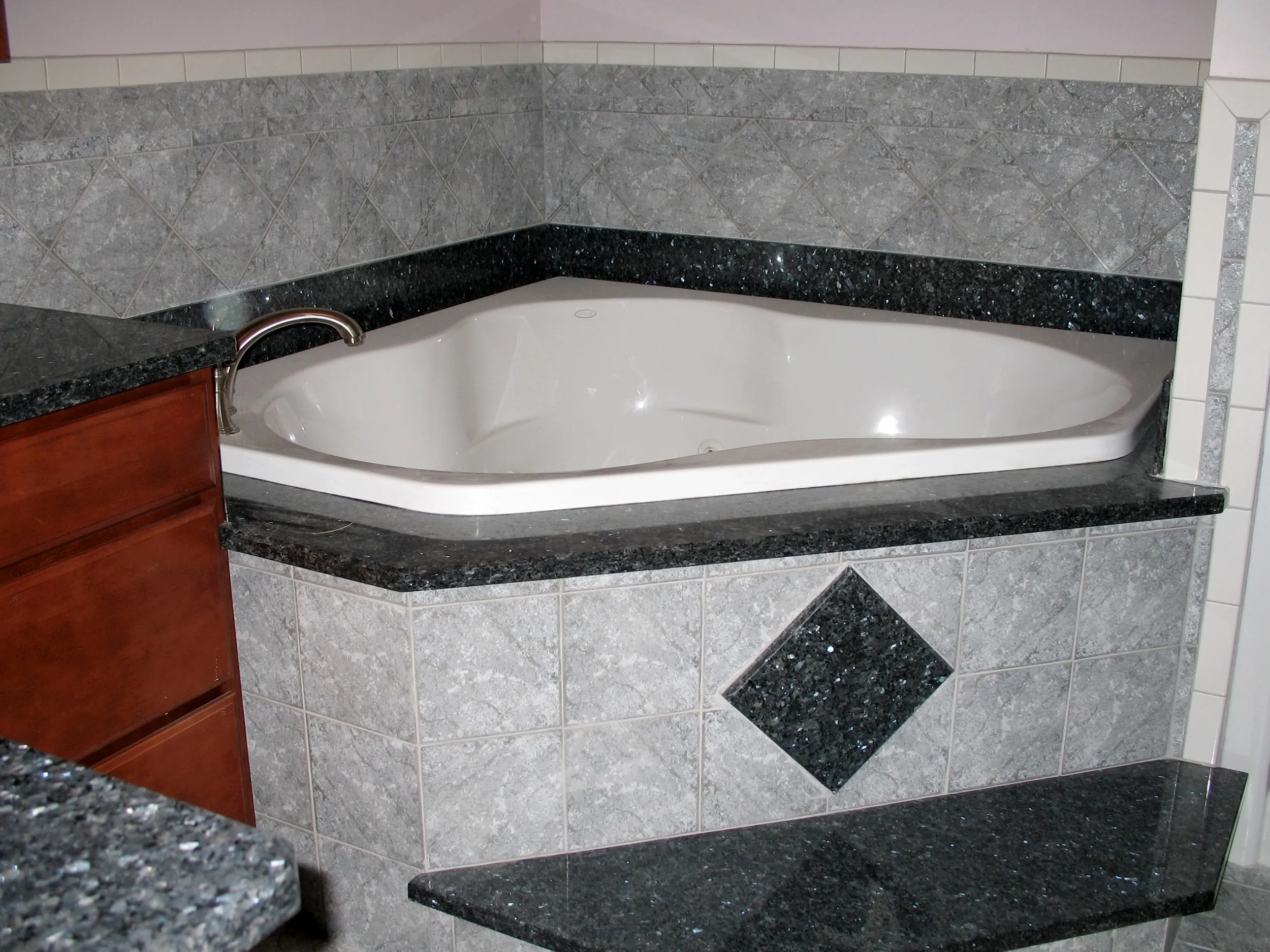 Black granite tub surround and bathroom stonework