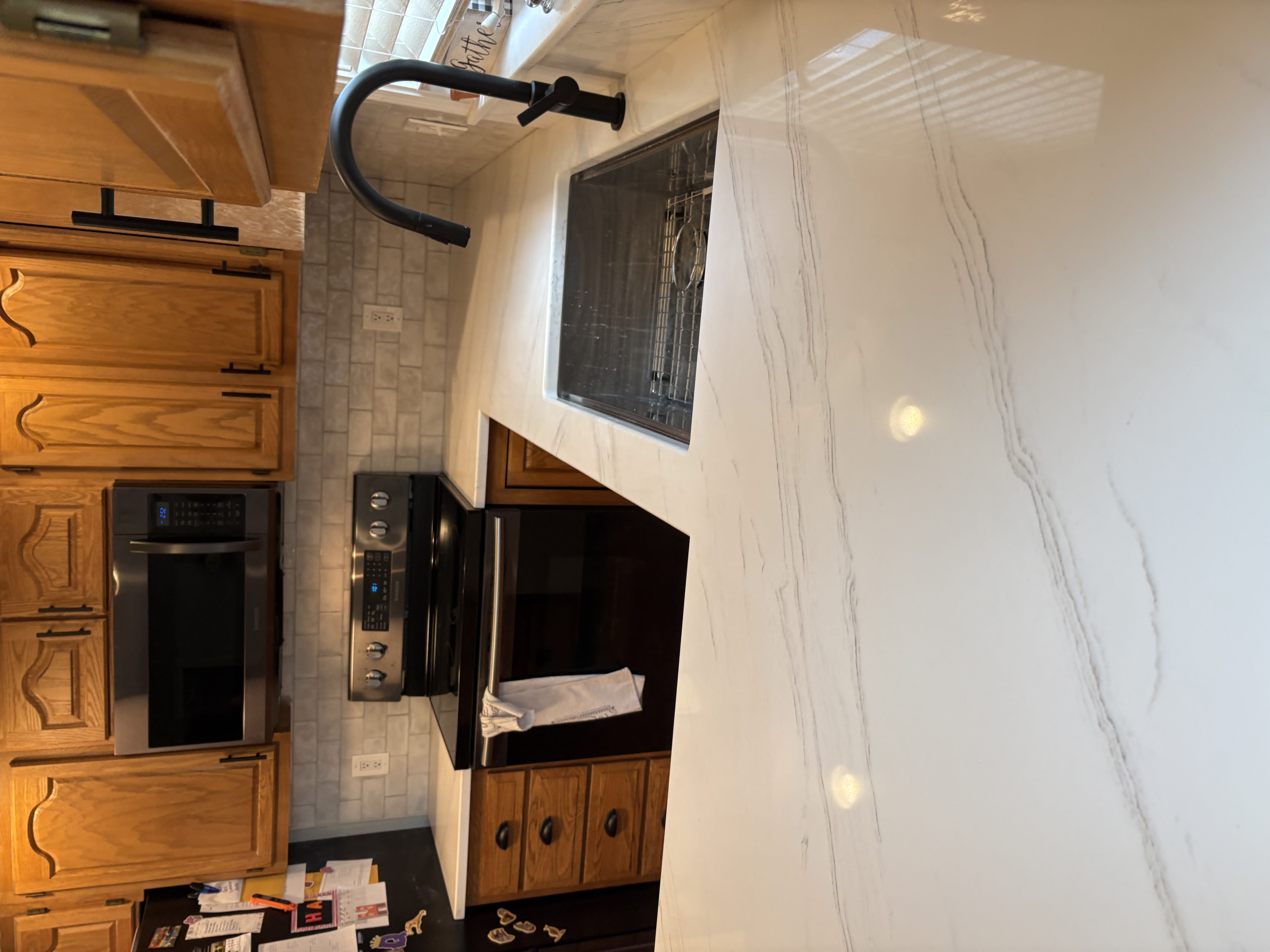 Close-up of white quartz kitchen island showing elegant gray veining pattern