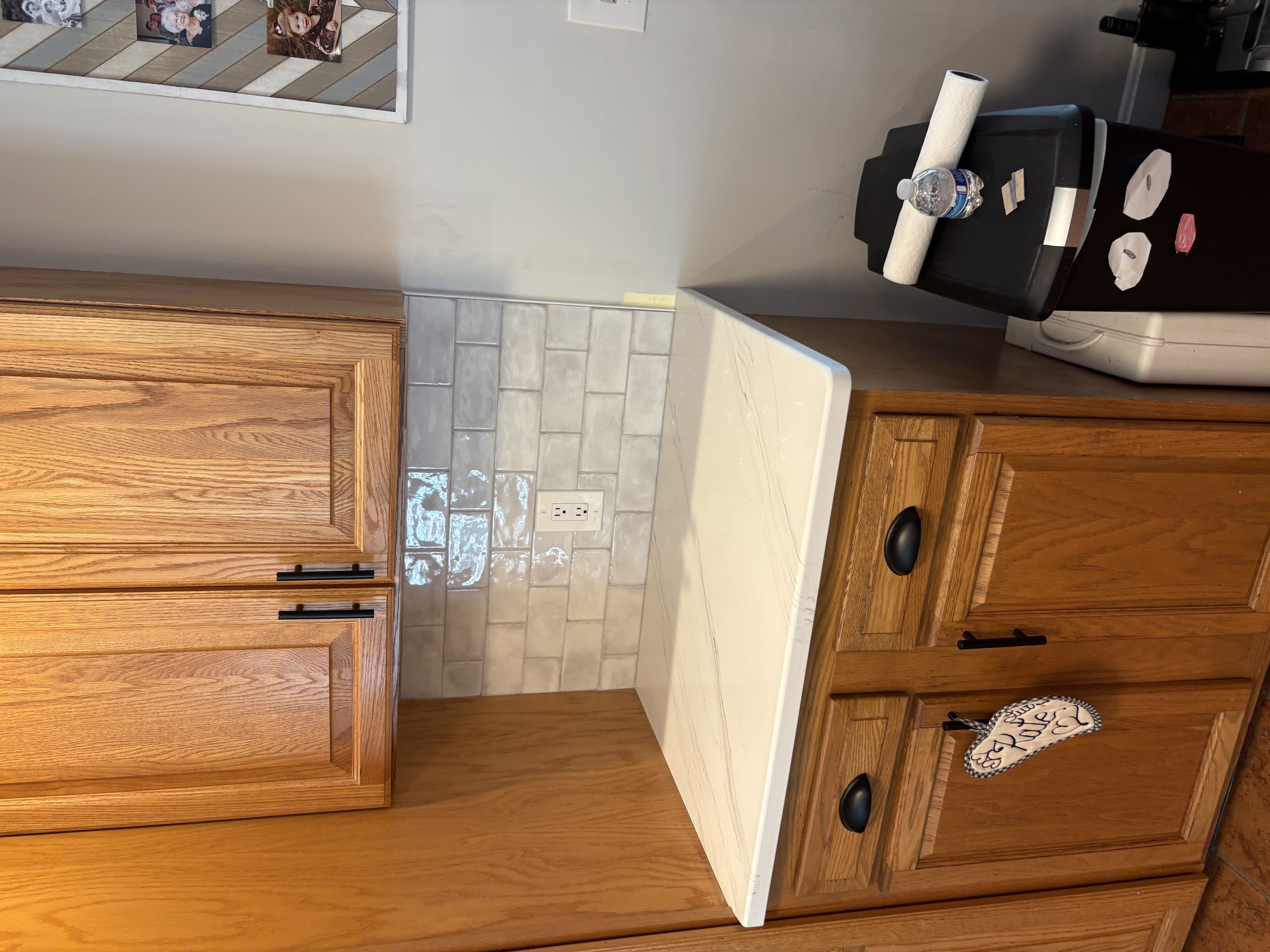 White quartz counter workspace paired with neutral subway tile backsplash