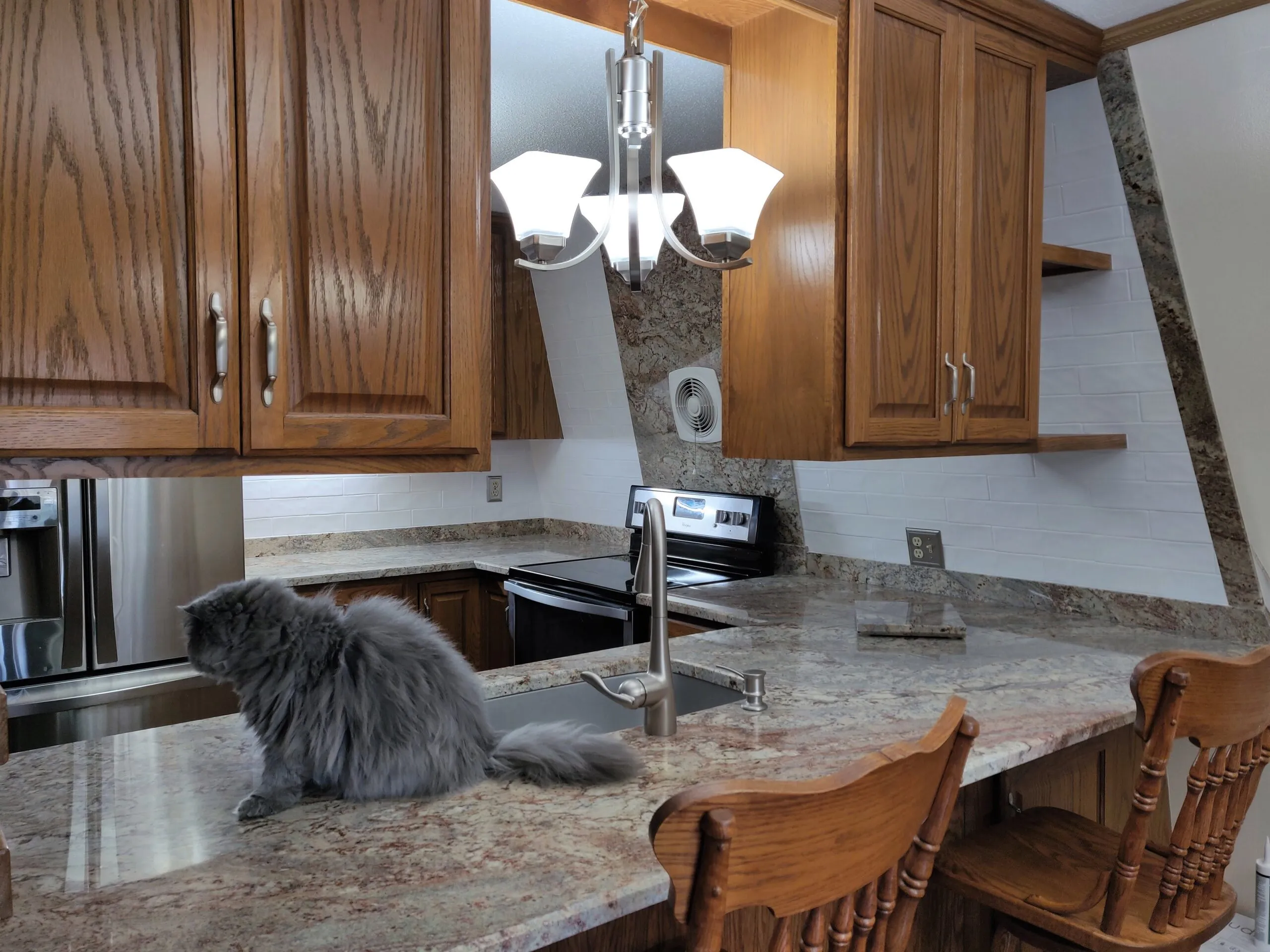 Granite kitchen island and countertops with custom backsplash