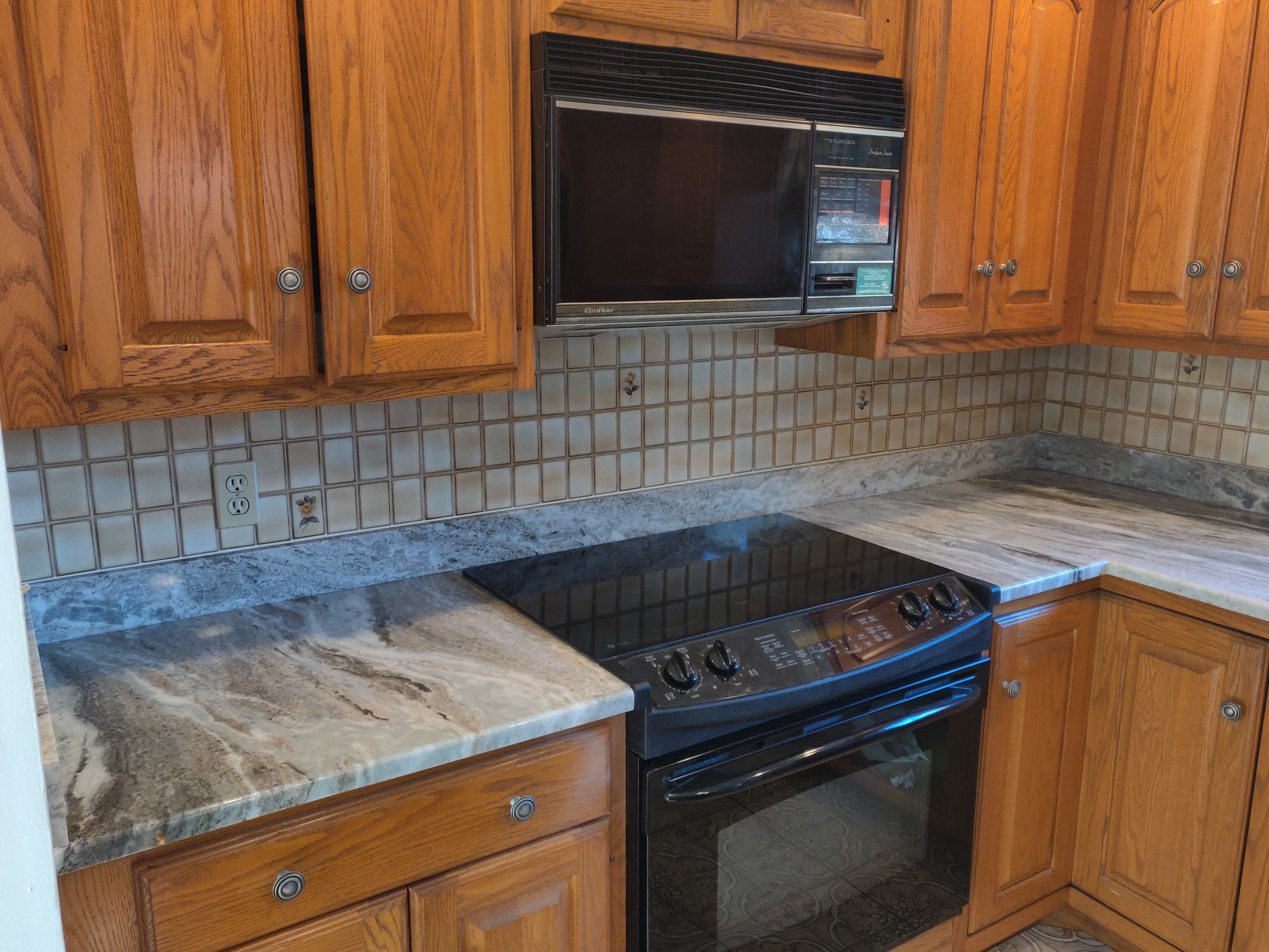 Granite countertop with range cutout showing dramatic veining