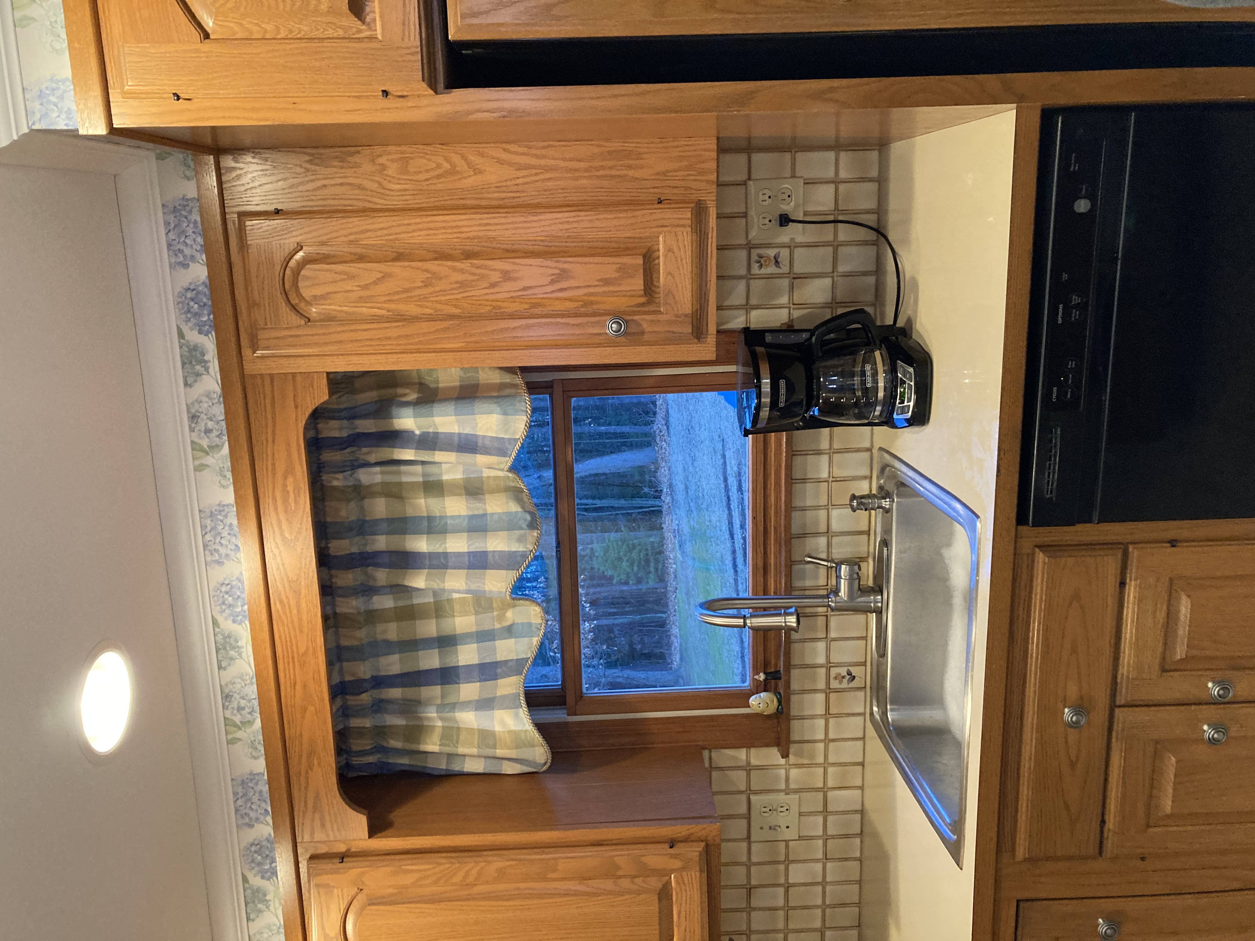 Kitchen with white laminate countertops before granite installation